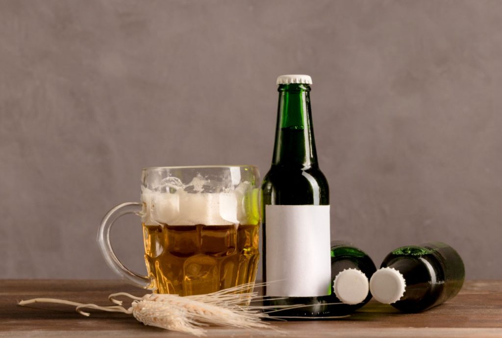 glass beer with foam green bottles beer wooden table 1024x690