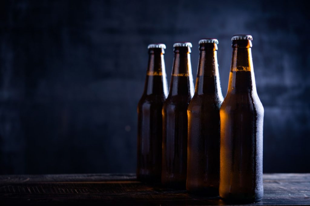 glass bottles beer with glass ice dark background 1024x683