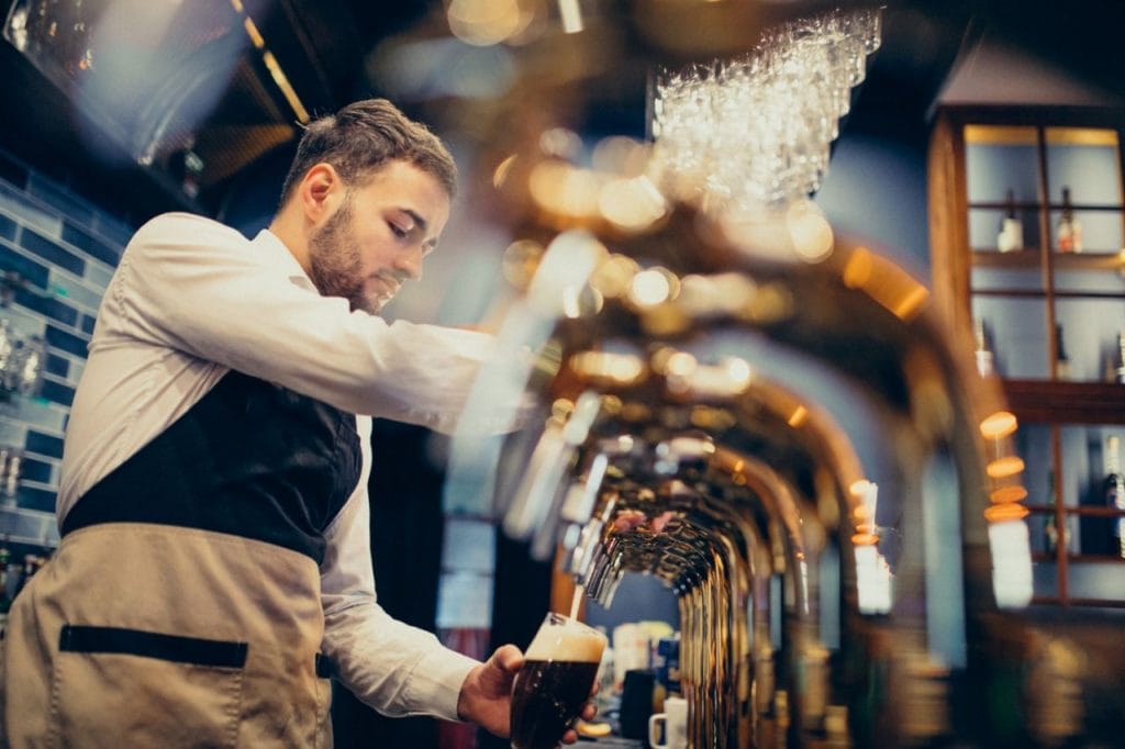 handsome bartender pouring beer pub 1024x682