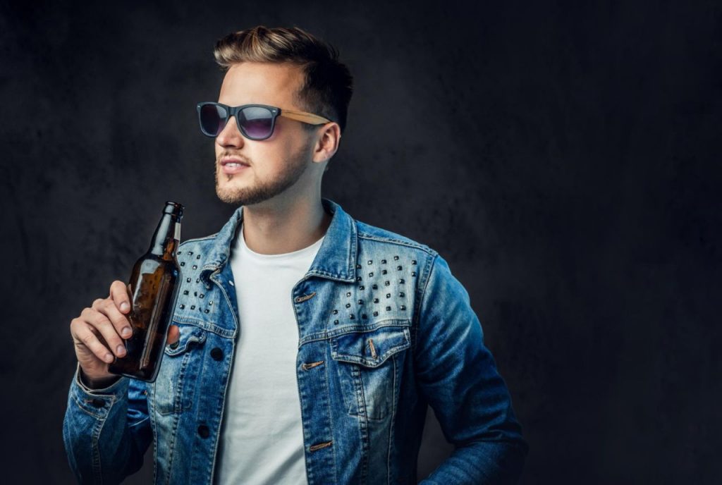 positive blond male dressed denim jacket sunglasses holds bottle with craft beer 1024x688